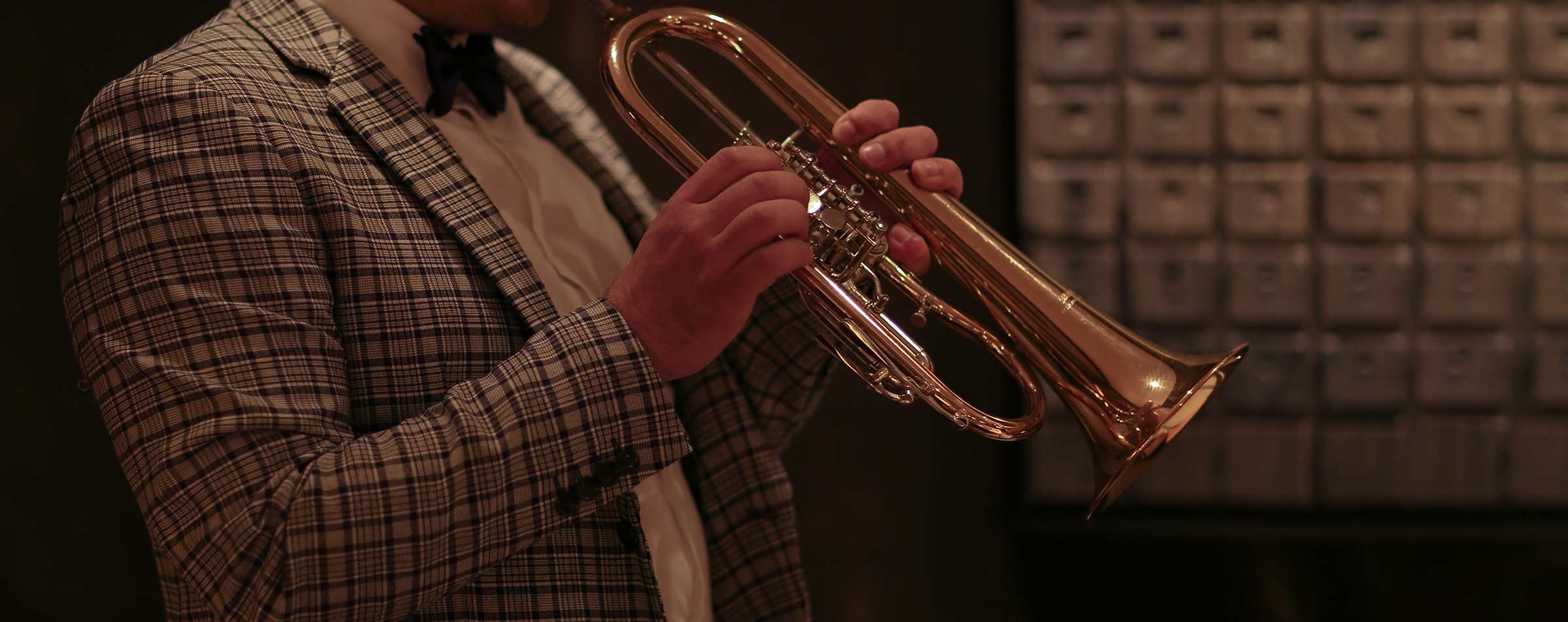 man blowing on trumpet