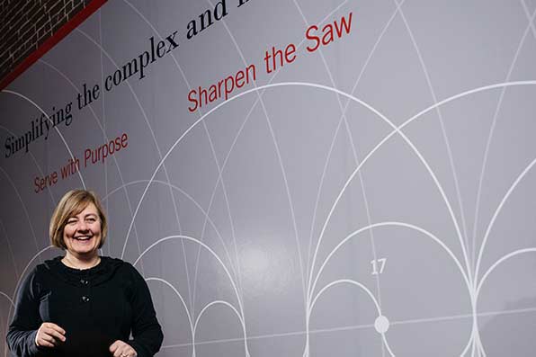 woman smiling in front of white board